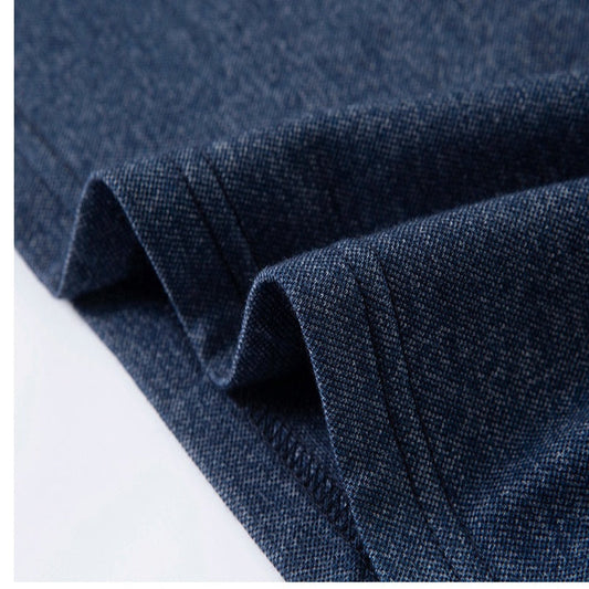 Close-up of blue denim fabric with a white background