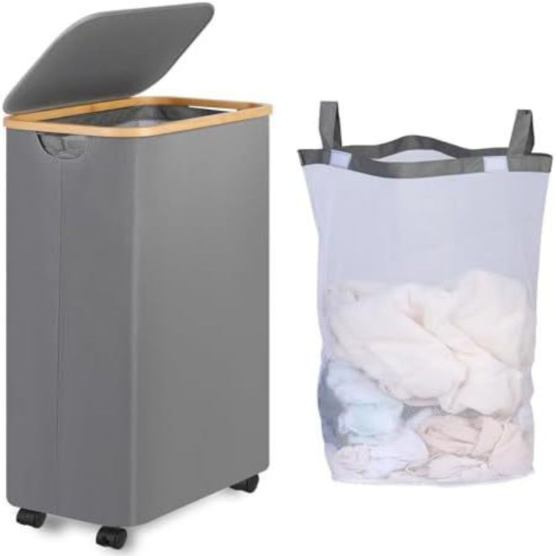 A person is holding a black laundry basket with wheels. The image highlights the washable and detachable inner bag of the basket.