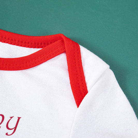 Close-up of a white shirt with red trim on a green background