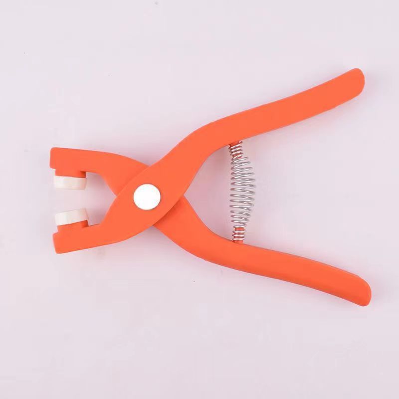 Orange plier-like tool with a spring on a white background