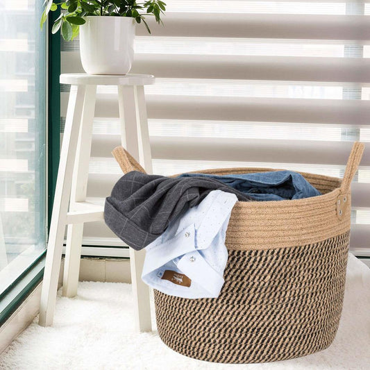 Woven laundry basket with clothes on a windowsill with blinds
