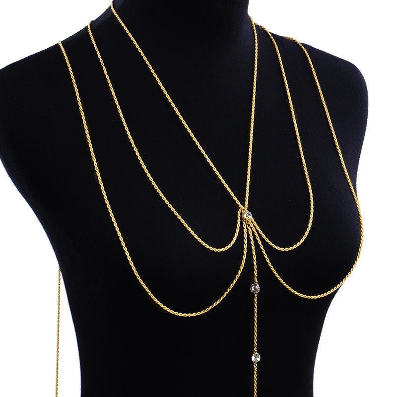 Gold chain necklace on a black mannequin