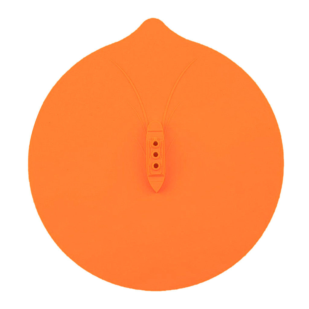 A blue silicone steamer lid on top of a pot allowing steam to escape, set against a dark background.