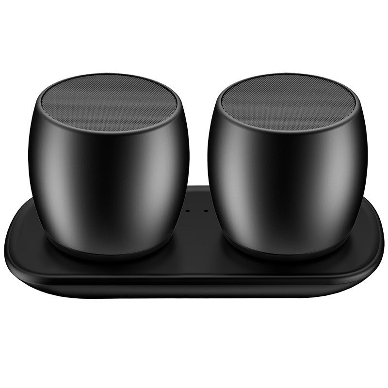 Two black Bluetooth speakers with a magnetic connection base