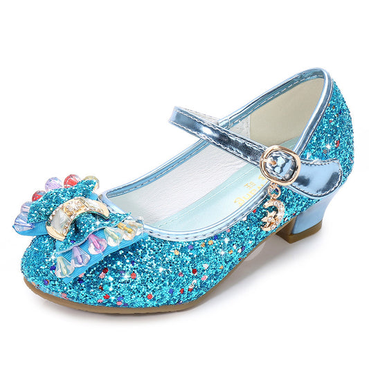 Blue glittery shoe with decorative bow on a white background