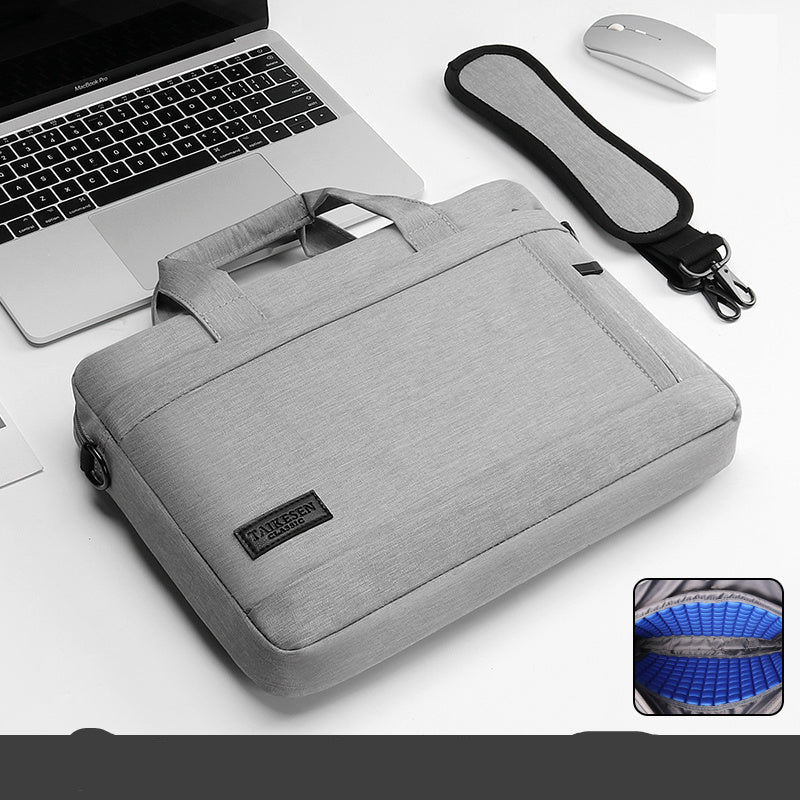 Black laptop bag with a handle and zipper closure, displayed next to a laptop and a mouse, with an inset showing the interior of the bag.