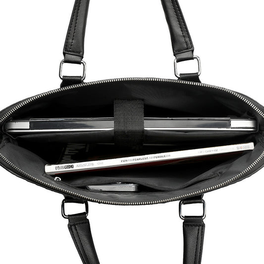 Black handbag with interior compartments and a visible brand name on a white background