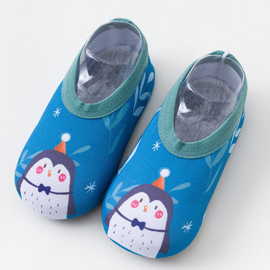 Pair of blue children's shoes with penguin design on a white background