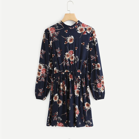 Floral dress on a hanger against a white background