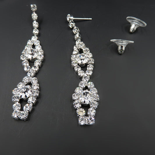 Pair of silver and crystal earrings on a dark background