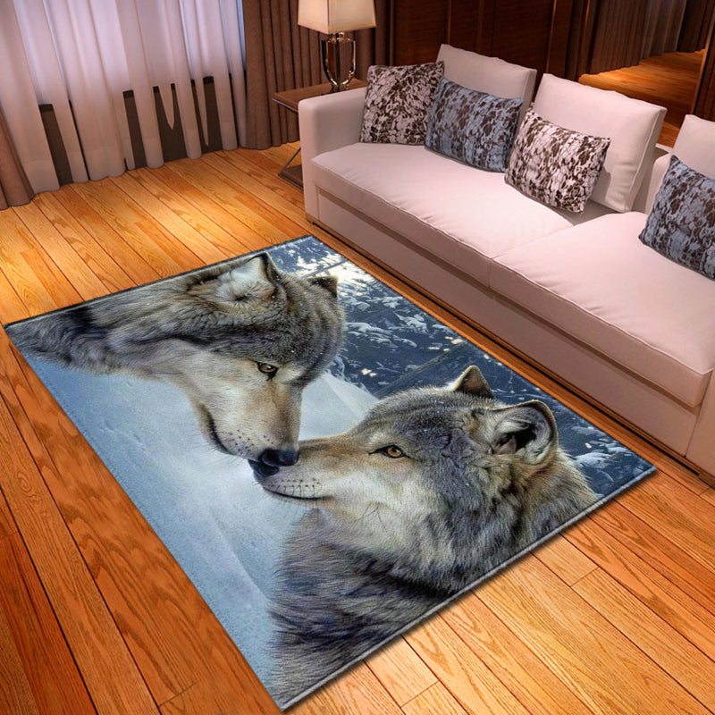 Living room with a rug featuring two wolves on a wooden floor.
