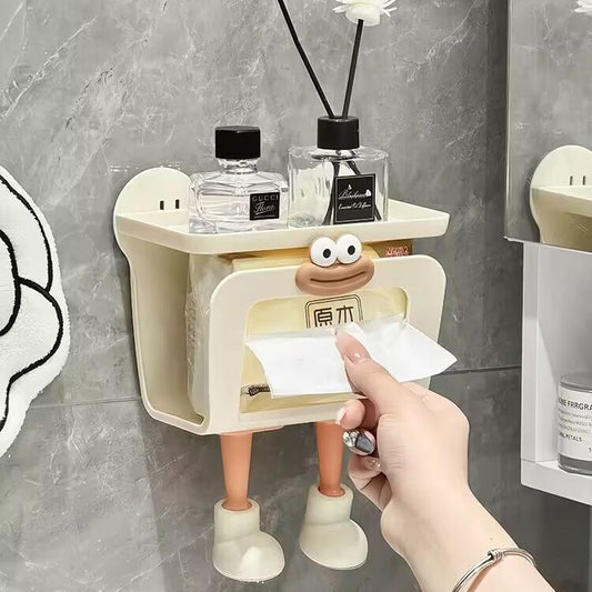 Person using a cartoon character-themed tissue holder on a bathroom wall.
