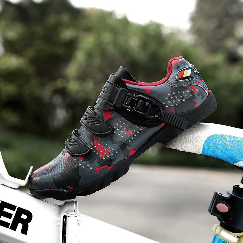 Black and red cycling shoe on a bicycle with a blurred green background