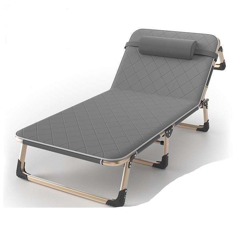 Gray folding bed with quilted surface on a white background