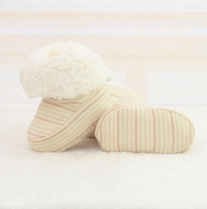 Three cream-colored pillows on a light beige background