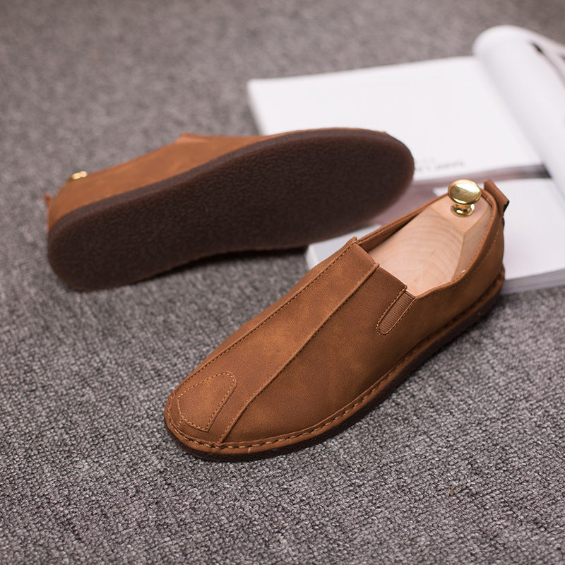 Brown loafers on a textured gray surface