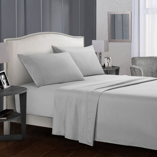 Gray bed sheets and pillows in a bedroom setting.