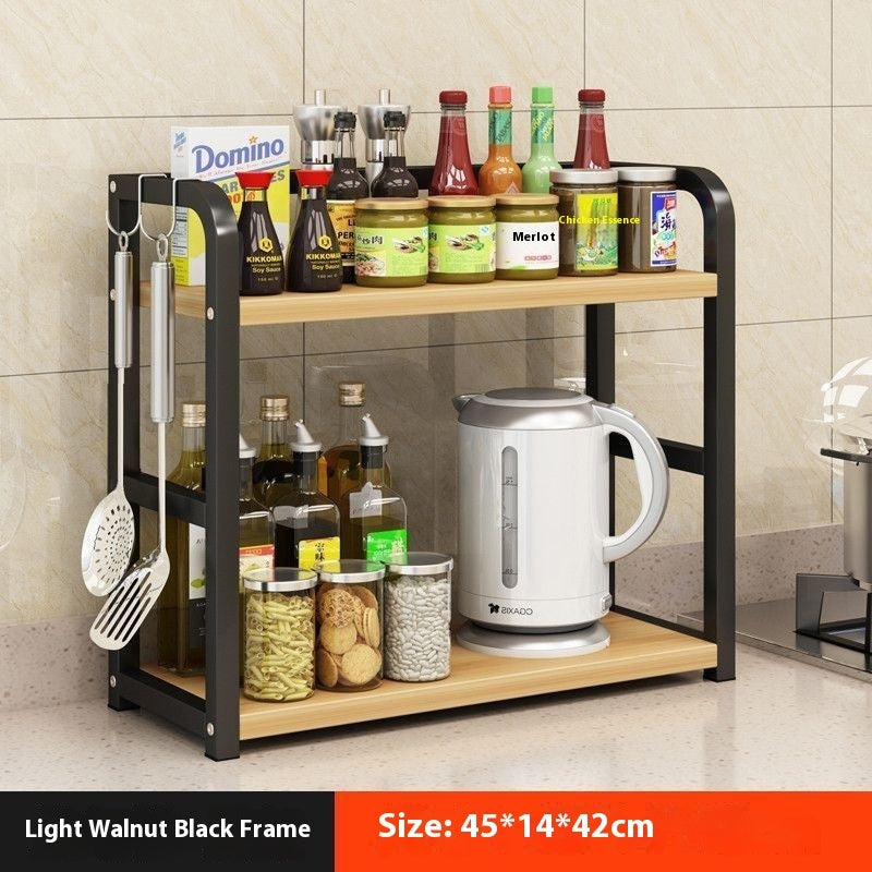 A black metal multi-functional storage rack on a kitchen countertop, organized with jars and containers.