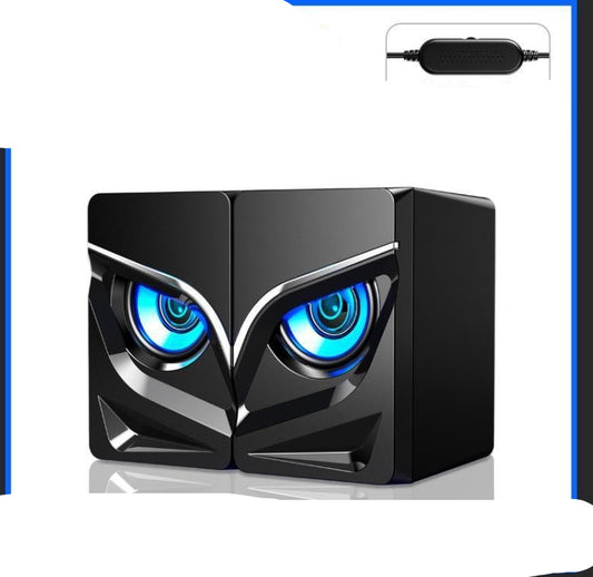A black desktop speaker with a design that resembles a character with eyes glowing in blue color.