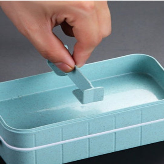 Hand opening a light blue storage box with a white rim on a gray background