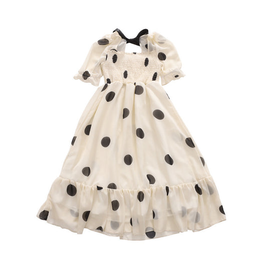 White dress with black polka dots on a white background