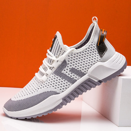 Gray and white sneaker on a white block with an orange background
