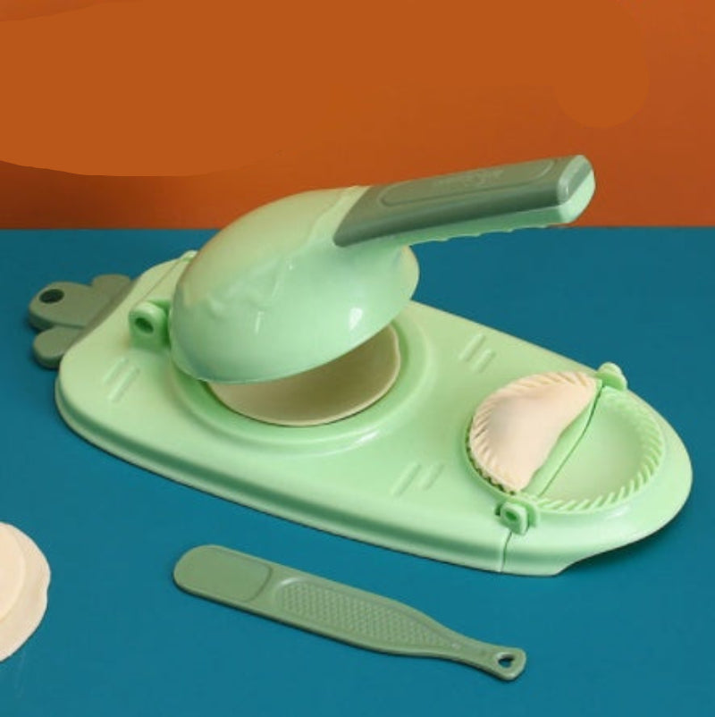 Green kitchen tool with attachments on a blue background