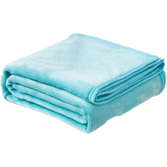 Folded light blue blanket on a white background