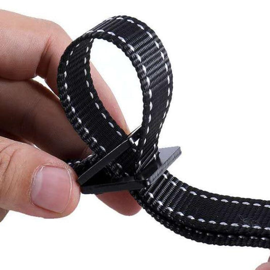 Black webbing strap with a metal clip held by a hand on a white background