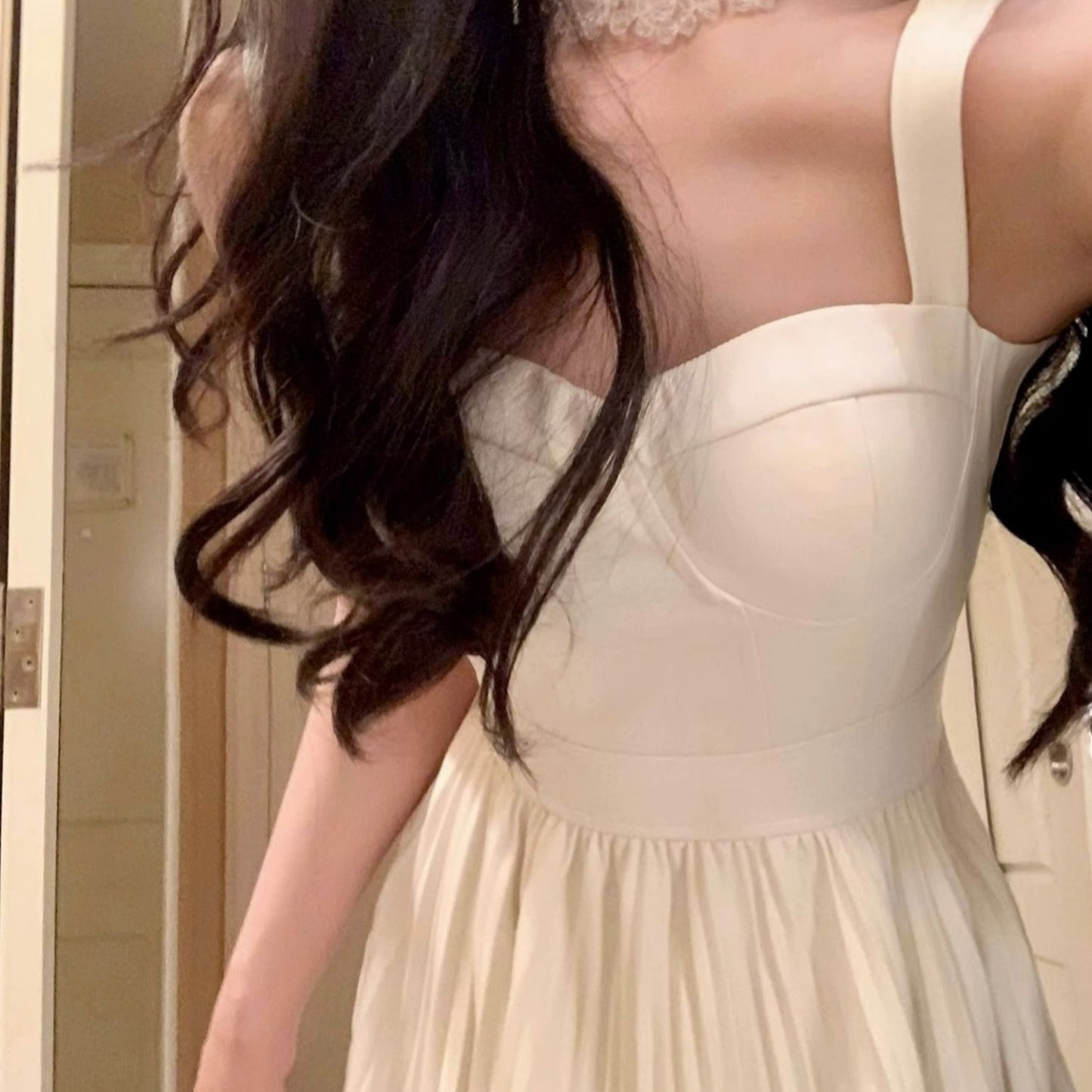 Woman wearing a beige dress with a neutral background