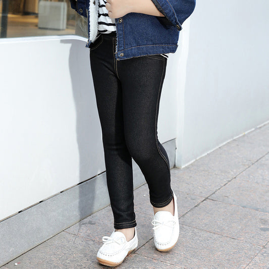 Person wearing black leggings and white shoes on a sidewalk.