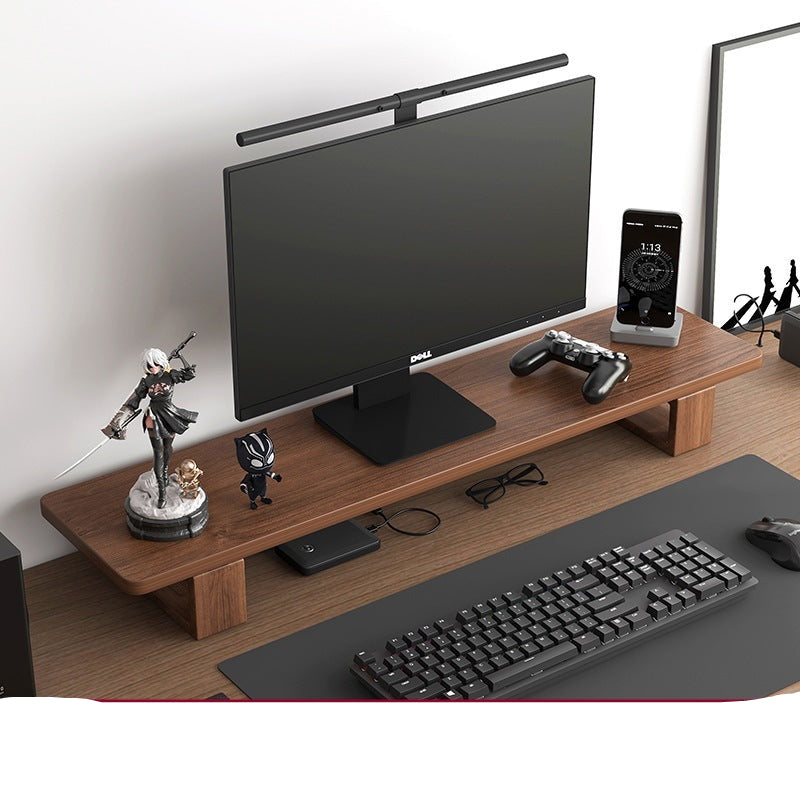 Wooden desk with computer monitor, keyboard, and phone on a white background