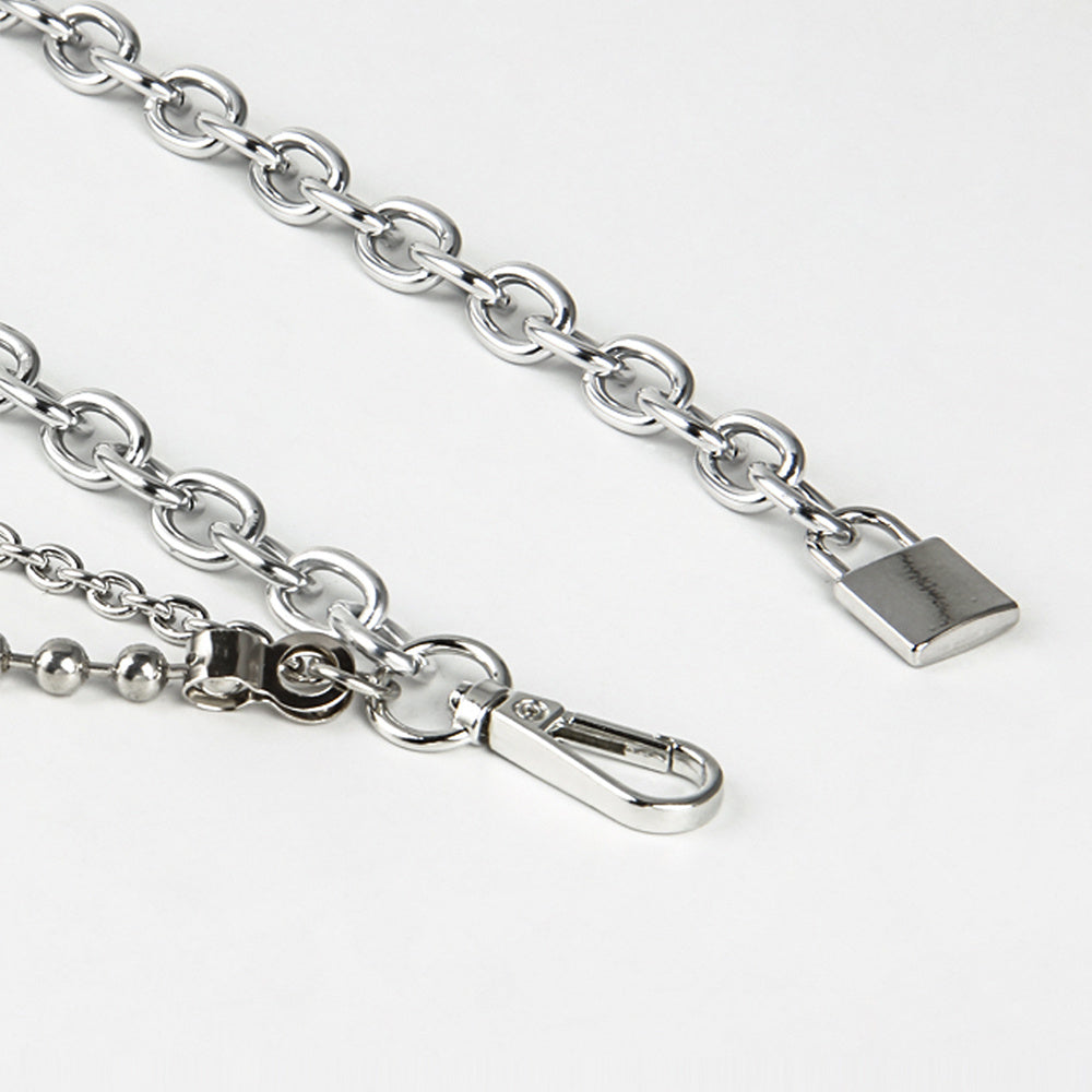 Close-up of a silver chain with clasp on a white background
