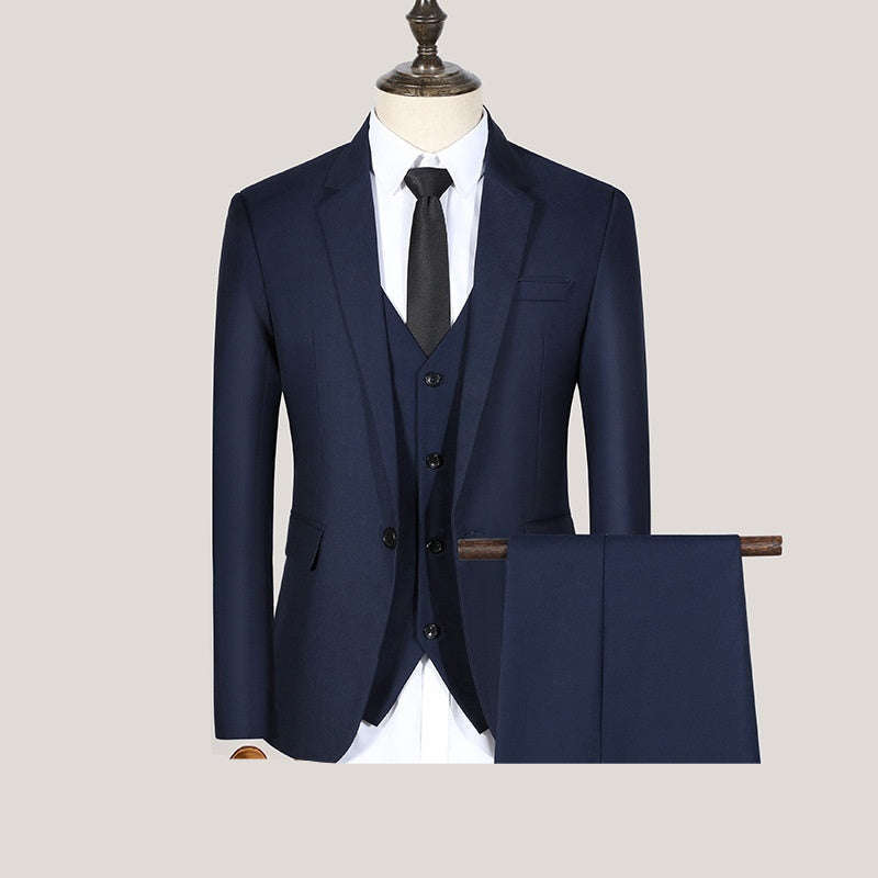 A navy blue three-piece suit with a one-button jacket, vest, and trousers, displayed on a mannequin.