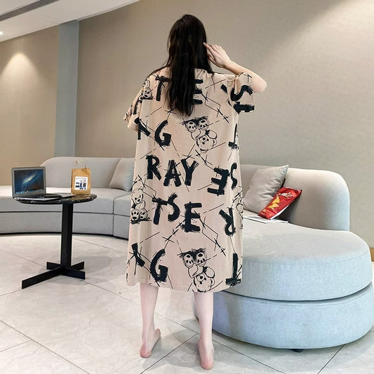 Woman wearing a long, patterned dress in a modern living room.