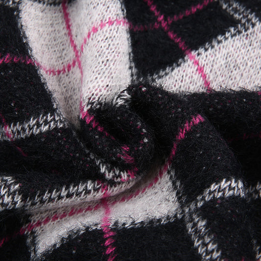 Close-up of black, white, and pink plaid fabric with a focus on texture and pattern.