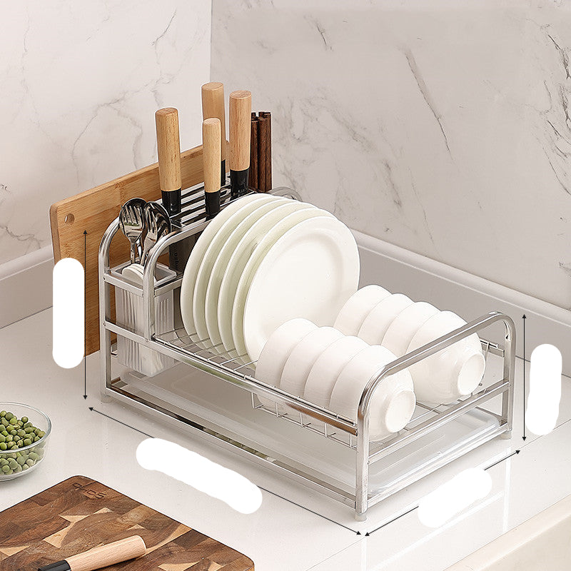 A black stainless steel kitchen dish drying rack with space for plates, cups, and utensils, shown with dishes and cutting boards stored on it.