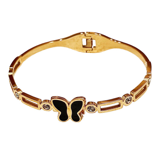 Gold bracelet with a butterfly design on a white background