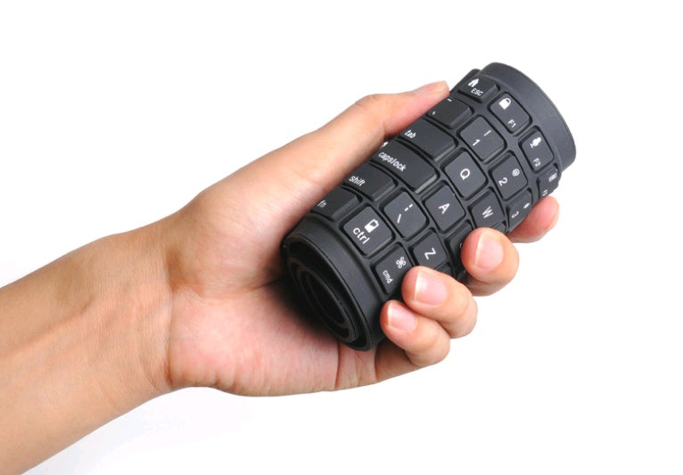 Black keyboard grip held in a hand on a white background