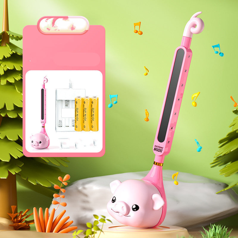 Pink musical toy with a pig design on a green background