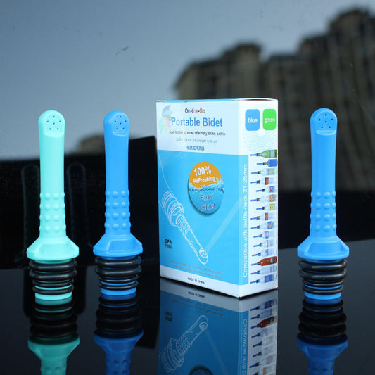 Blue portable bidet attachments with packaging on a reflective surface