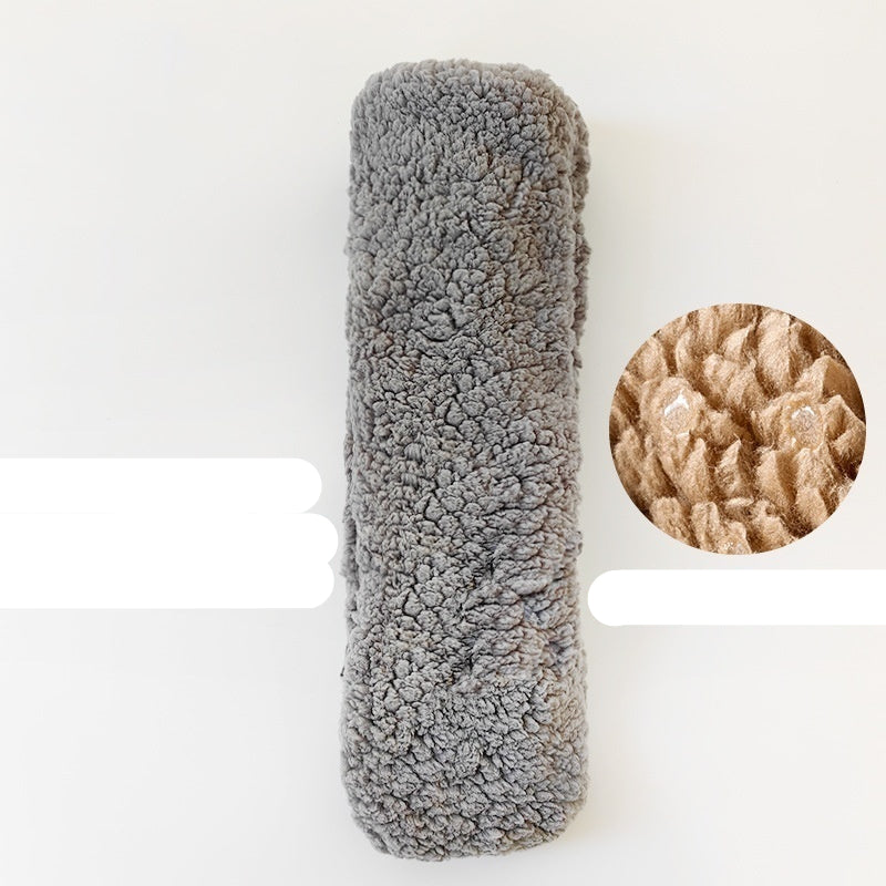 Gray textured cylindrical object on a white background with a close-up inset showing texture details.