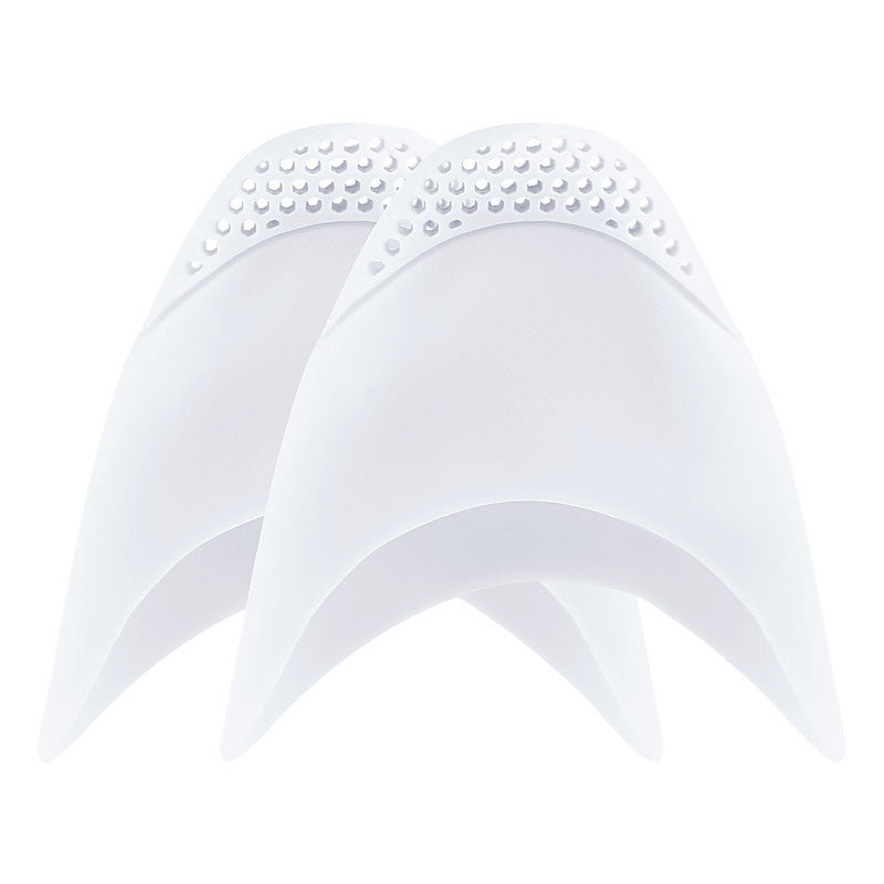 Two white silicone caps with textured top on a white background