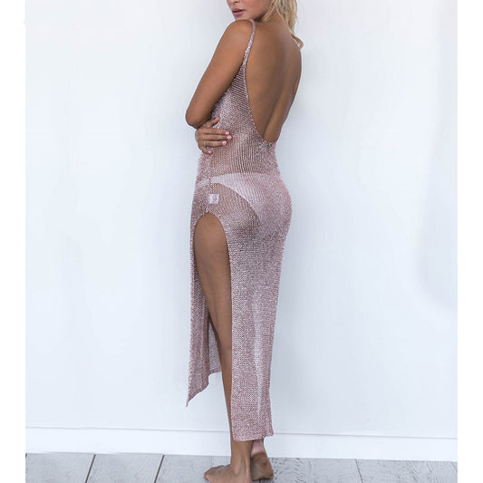 Woman wearing a sparkly dress with a high slit on a white background