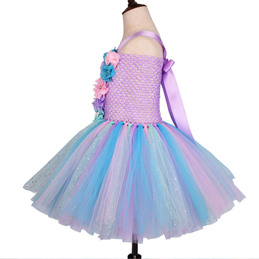 Colorful dress with floral details on a mannequin against a white background