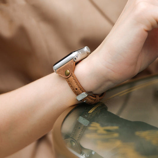 Smartwatch with a brown leather strap on a wrist, blurred background