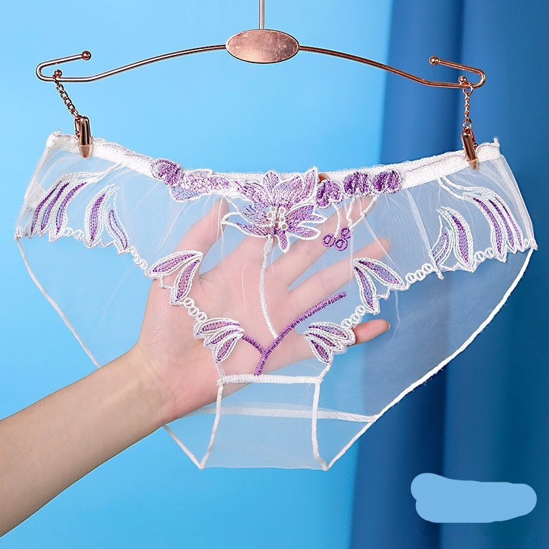 White lace underwear with purple floral embroidery on a hanger against a blue background.