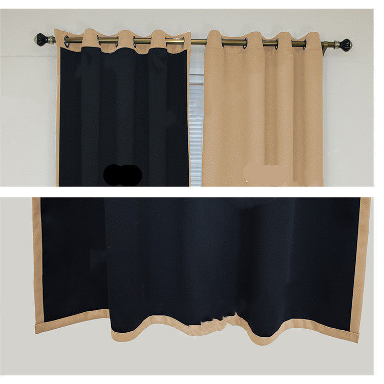Black and beige curtains with grommets on a rod against a white wall.