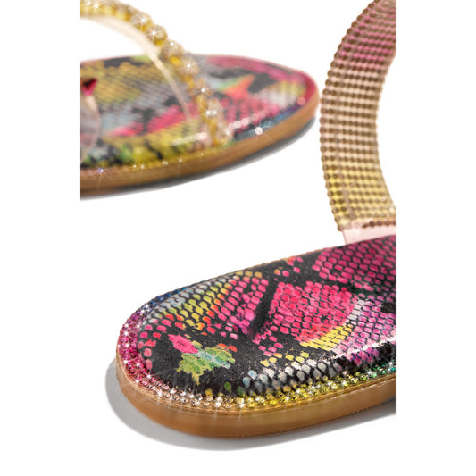 Colorful sandal with floral pattern and beaded strap on a white background