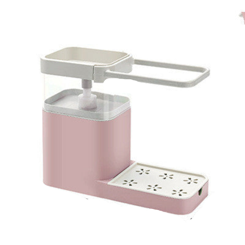A blue dishwashing liquid dispenser with a towel bar shelf attached to a kitchen sink, with a person rinsing a plate in the background.